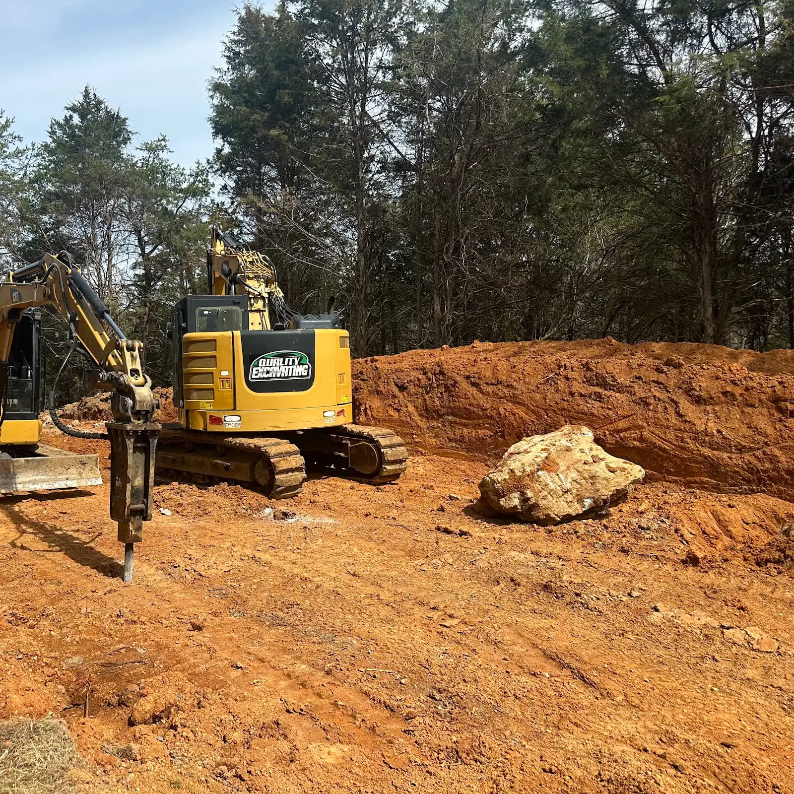 Quality Excavating equipment working on a cleared construction site